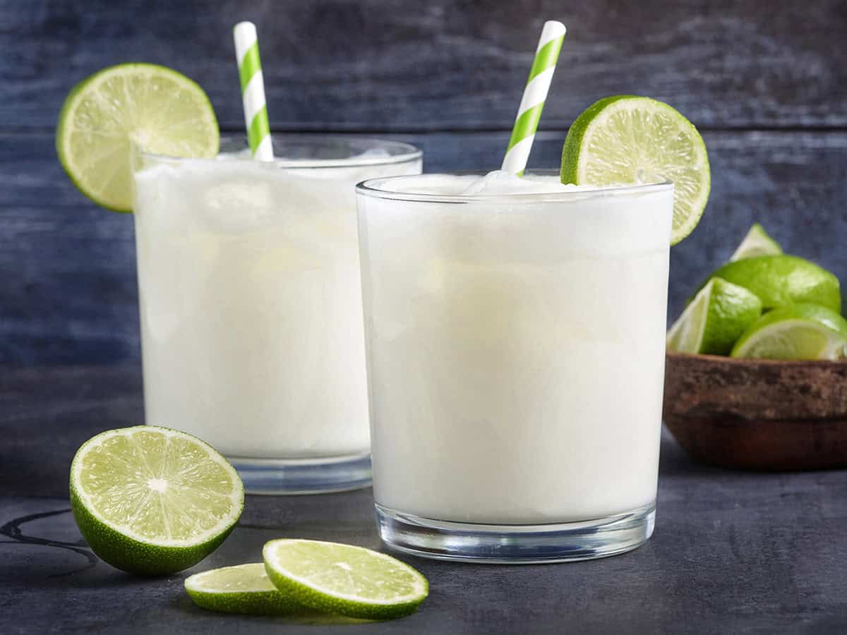 Side view of two glasses of homemade Brazilian lemonade.