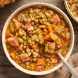 Overhead view of a bowl of lentil and ham soup.