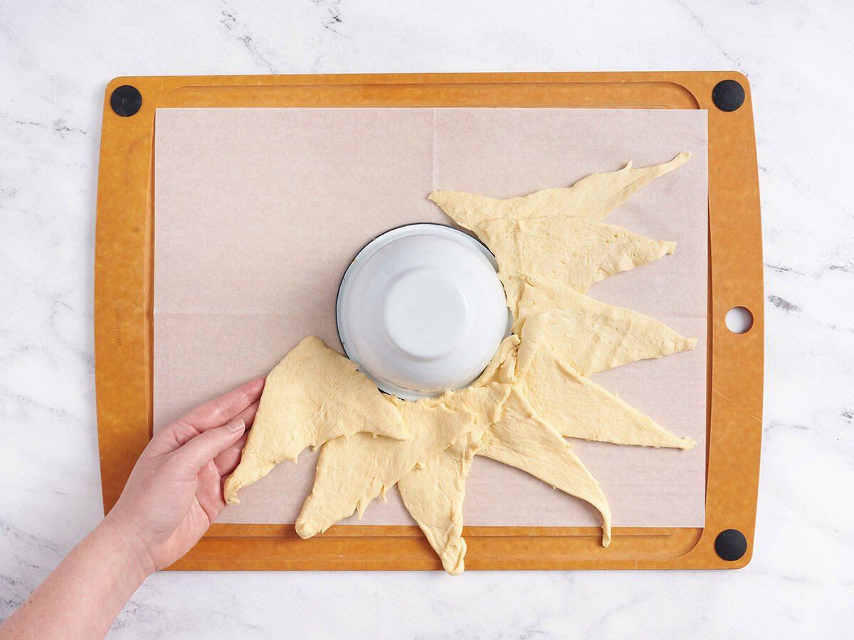 Laying out the crescent rolls around the bowl.