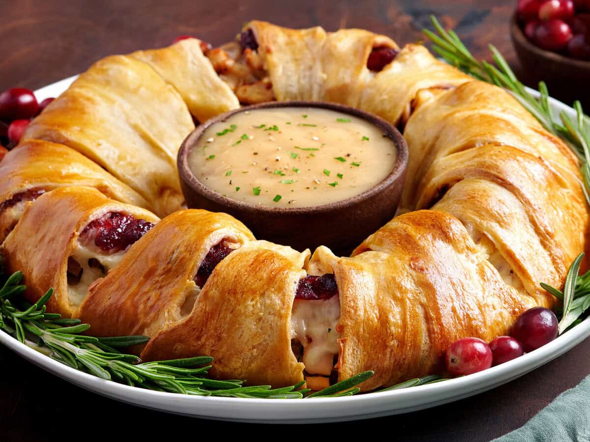 Holiday leftovers wreath with a bowl of gravy in the middle. 