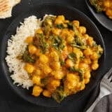 Overhead view of coconut curry chickpeas on a plate with white rice.