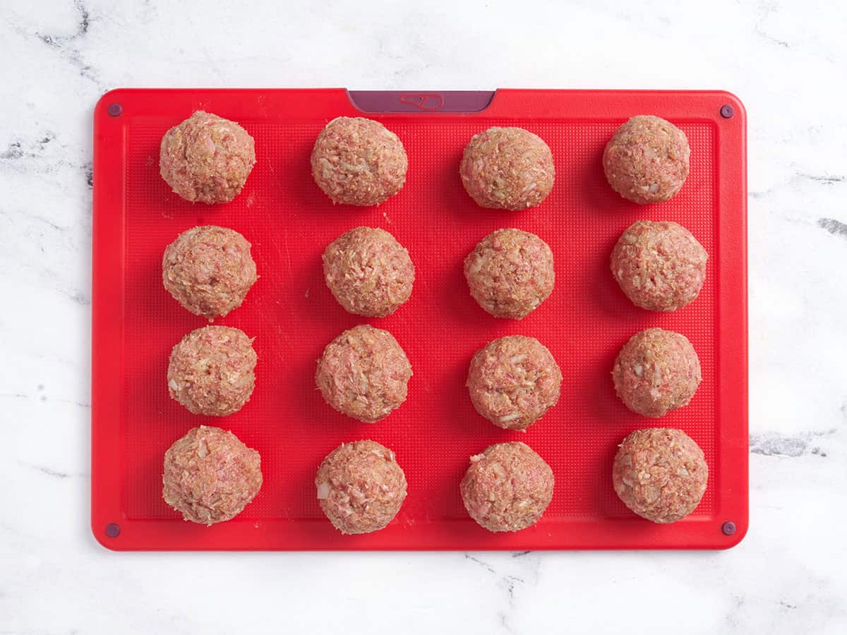 Formed meatballs on a cutting board.