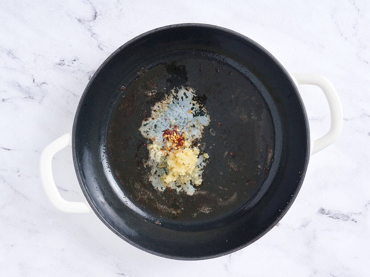 Butter, garlic and chili flakes in a skillet.