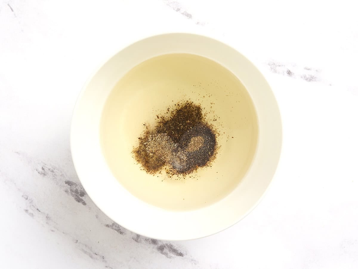 Oil and seasonings in a bowl.